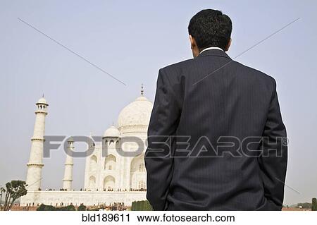 Stock Image - Indian businessman visiting the Taj Mahal. Fotosearch