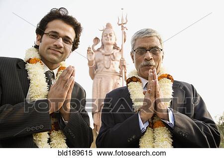 Indian businessmen wearing floral necklaces at tourist attraction View Large Photo Image Stock Photography - Indian businessmen wearing floral necklaces at tourist attraction. Fotosearch