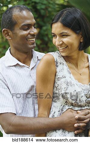 Picture - Indian couple hugging outdoors. Fotosearch