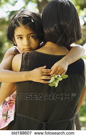 Stock Photo - Indian daughter hugging mother. Fotosearch