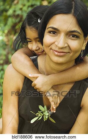 Stock Photograph - Indian daughter hugging mother. Fotosearch
