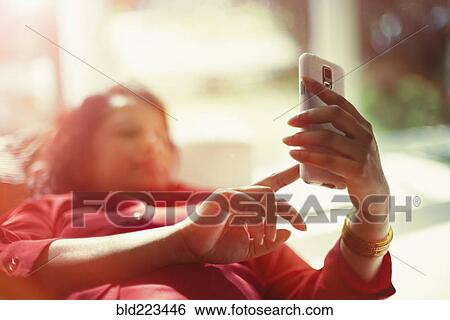 Stock Photograph - Indian woman using cell phone. Fotosearch