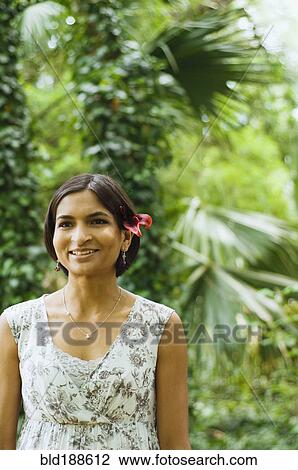Indian woman with flower in her hair View Large Photo Image Stock Image - Indian woman with flower in her hair. Fotosearch