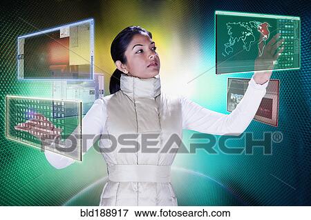 Stock Photo - Indian woman working at futuristic control panels. Fotosearch