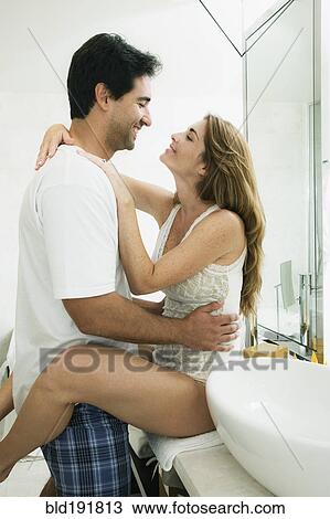 Stock Image - Intimate Hispanic couple in bathroom. Fotosearch