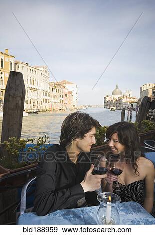 Italian couple drinking red wine at sidewalk cafe View Large Photo Image Stock Photo - Italian couple drinking red wine at sidewalk cafe. Fotosearch