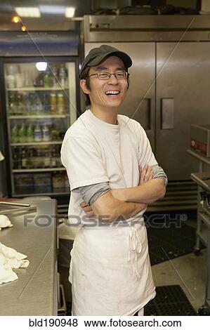 Japanese chef smiling with arms crossed View Large Photo Image Stock Photo - Japanese chef smiling with arms crossed. Fotosearch