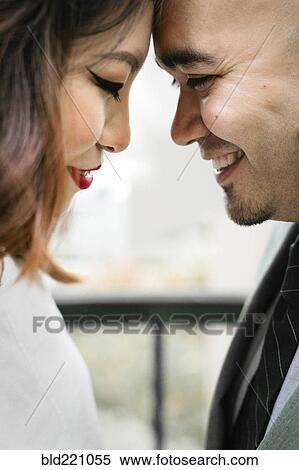 Stock Photography - Japanese couple touching foreheads. Fotosearch