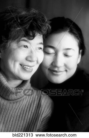 Stock Image - Japanese mother and daughter smiling. Fotosearch
