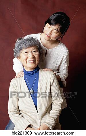 Stock Photo - Japanese mother and daughter smiling. Fotosearch