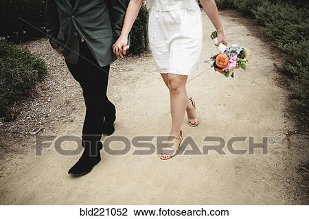 Stock Image - Japanese newlywed couple walking outdoors. Fotosearch