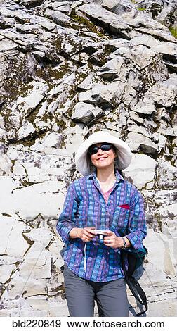 Japanese tourist photographing rock formation View Large Photo Image Stock Photo - Japanese tourist photographing rock formation. Fotosearch