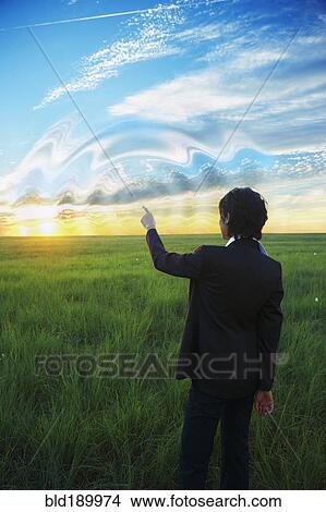 Kazakh businesswoman swirling sky with finger View Large Photo Image Picture - Kazakh businesswoman swirling sky with finger. Fotosearch