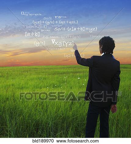 Stock Image - Kazakh businesswoman writing mathematical equations in sky. Fotosearch