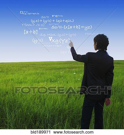 Stock Image - Kazakh businesswoman writing mathematical equations in sky. Fotosearch