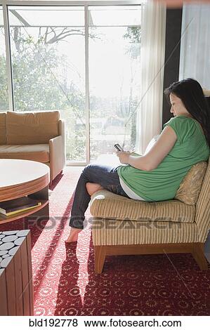 Korean woman text messaging on cell phone View Large Photo Image Stock Photo - Korean woman text messaging on cell phone. Fotosearch