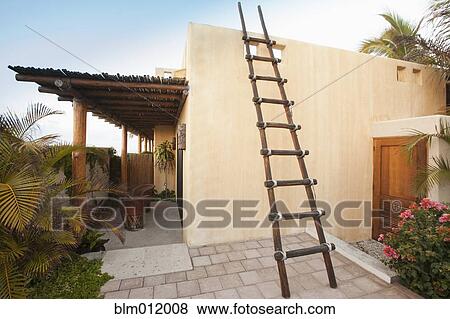 Stock Photo - Ladder on Mexican style home. Fotosearch