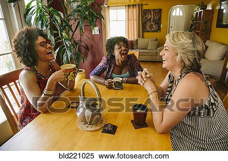 Stock Photography - Laughing women drinking coffee. Fotosearch