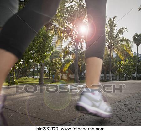 Legs of Caucasian woman jogging in city View Large Photo Image Stock Photo - Legs of Caucasian woman jogging in city. Fotosearch