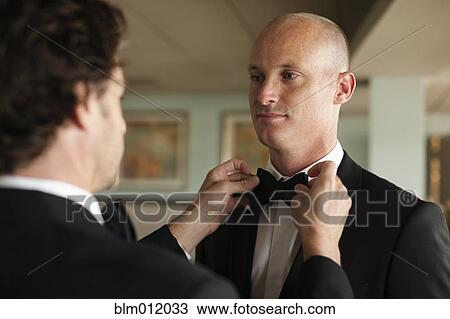 Man adjusting groom's bow tie View Large Photo Image Stock Image - Man adjusting groom's bow tie. Fotosearch