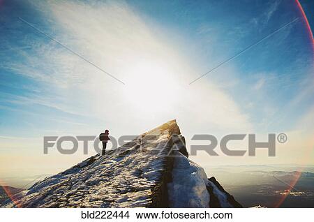 Picture - Man hiking on mountain in winter. Fotosearch