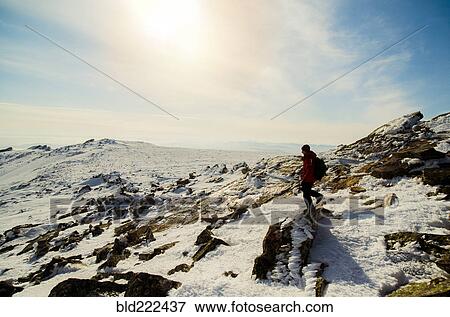 Stock Photo - Man hiking on mountain in winter. Fotosearch