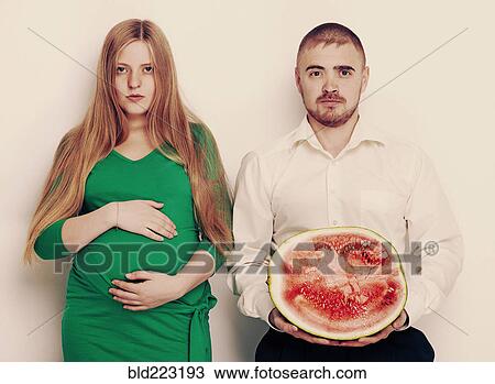 Man holding watermelon with pregnant girlfriend View Large Photo Image Stock Image - Man holding watermelon with pregnant girlfriend. Fotosearch
