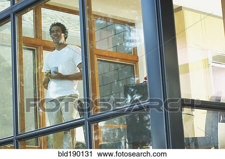 Man looking through window View Large Photo Image Stock Image - Man looking through window. Fotosearch