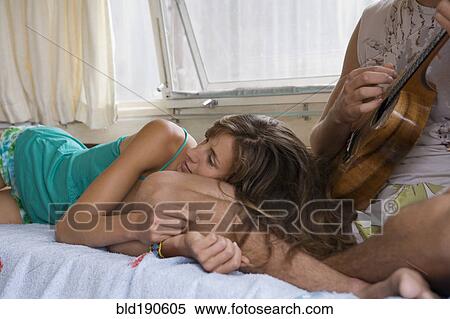 Man playing ukulele for girlfriend View Large Photo Image Stock Photography - Man playing ukulele for girlfriend. Fotosearch