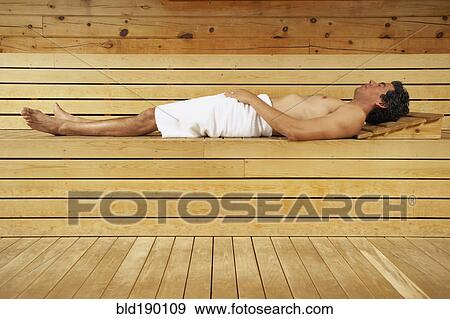 Man relaxing in sauna View Large Photo Image Stock Photo - Man relaxing in sauna. Fotosearch