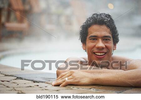 Stock Photography - Man sitting in hot tub. Fotosearch