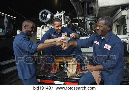 Mechanics eating lunch together View Large Photo Image Stock Photo - Mechanics eating lunch together. Fotosearch