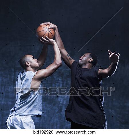 Stock Image - Men playing basketball. Fotosearch