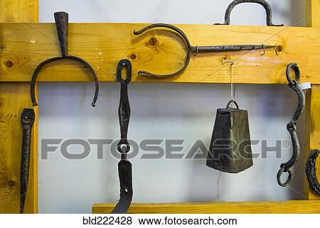 Stock Photo - Metal blacksmith products hanging on wood frame. Fotosearch