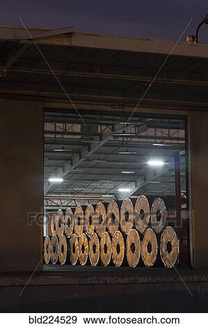 Metal rolls on warehouse loading dock View Large Photo Image Stock Photo - Metal rolls on warehouse loading dock. Fotosearch