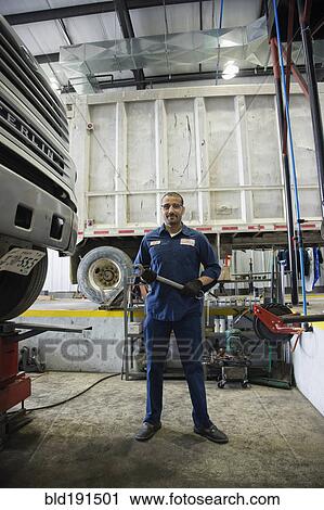 Stock Image - Middle Eastern mechanic in repair shop. Fotosearch