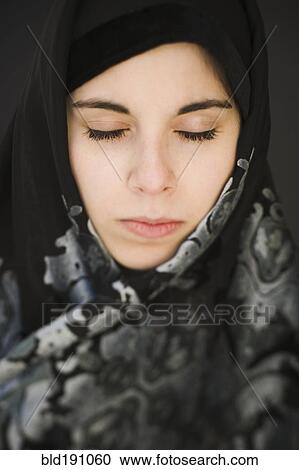 Middle Eastern teenager in headscarf with eyes closed View Large Photo Image Stock Image - Middle Eastern teenager in headscarf with eyes closed. Fotosearch
