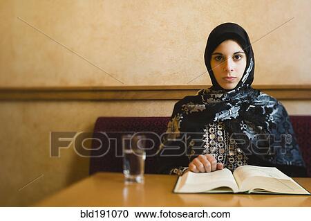 Middle Eastern teenager in headscarf reading book View Large Photo Image Stock Image - Middle Eastern teenager in headscarf reading book. Fotosearch