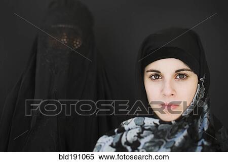 Stock Photography - Middle Eastern woman in burka and teenager in headscarf. Fotosearch