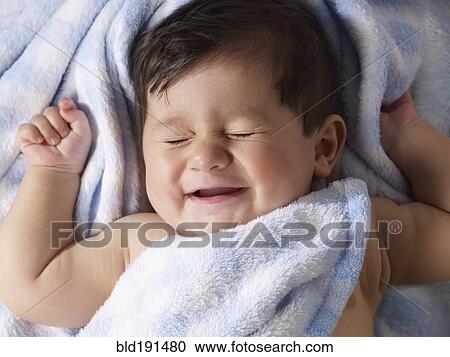 Stock Image - Mixed race baby boy laying on blanket. Fotosearch
