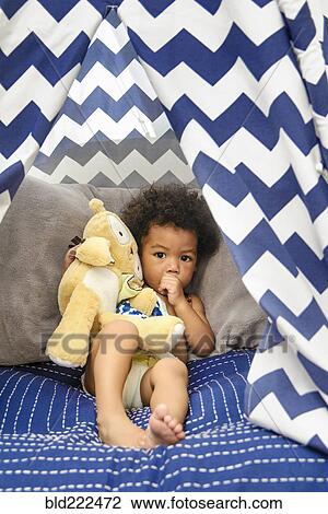 Mixed Race baby boy sucking thumb holding stuffed animal View Large Photo Image Stock Image - Mixed Race baby boy sucking thumb holding stuffed animal. Fotosearch