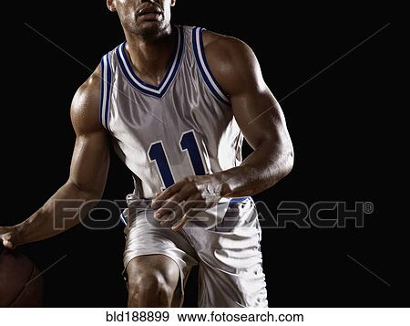 Mixed race basketball player bouncing basketball View Large Photo Image Stock Photo - Mixed race basketball player bouncing basketball. Fotosearch
