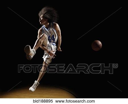 Stock Photography - Mixed race basketball player passing basketball. Fotosearch