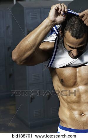 Mixed race basketball player undressing in locker room View Large Photo Image Stock Image - Mixed race basketball player undressing in locker room. Fotosearch