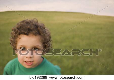 Stock Photo - Mixed race boy in field. Fotosearch