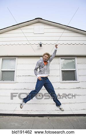 Mixed race boy jumping in mid-air View Large Photo Image Stock Image - Mixed race boy jumping in mid-air. Fotosearch