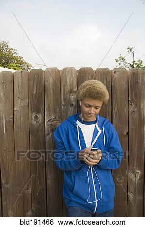 Mixed race boy listening to mp3 player View Large Photo Image Stock Photograph - Mixed race boy listening to mp3 player. Fotosearch