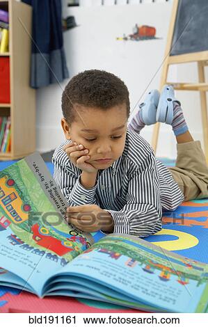 Mixed race boy reading storybook View Large Photo Image Stock Image - Mixed race boy reading storybook. Fotosearch