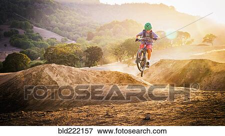 Mixed race boy riding dirt bike on track View Large Photo Image Stock Photo - Mixed race boy riding dirt bike on track. Fotosearch