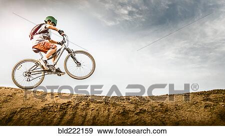 Mixed race boy riding dirt bike on track View Large Photo Image Stock Photo - Mixed race boy riding dirt bike on track. Fotosearch